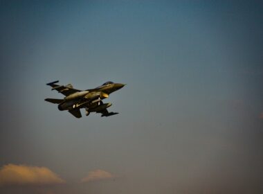 A group of fighter jets flying through a blue sky