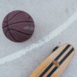 a skateboard and a basketball on the ground