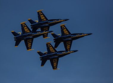 four black and yellow jet fighters