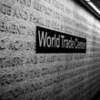 a black and white photo of a world trade center sign