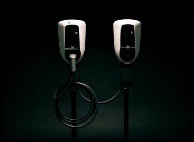 a couple of black and white phones on a black background