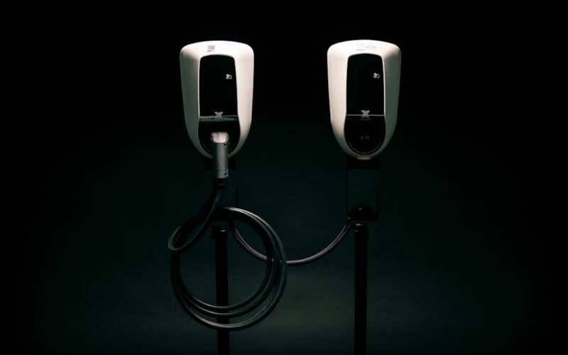 a couple of black and white phones on a black background
