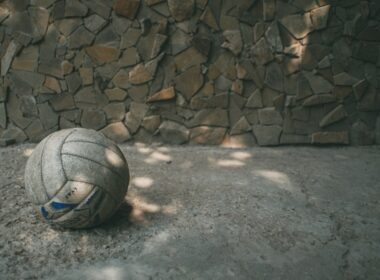 white and blue soccer ball on gray concrete floor