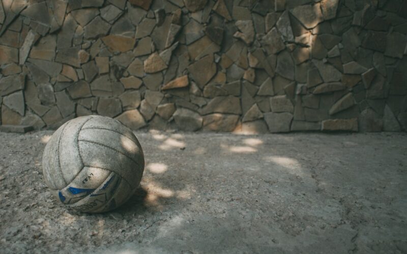white and blue soccer ball on gray concrete floor