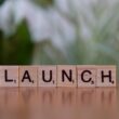 A scrabble block spelling out the word launch