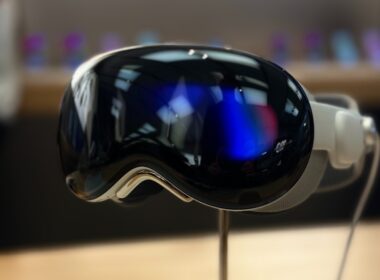 A pair of ski goggles sitting on top of a wooden table