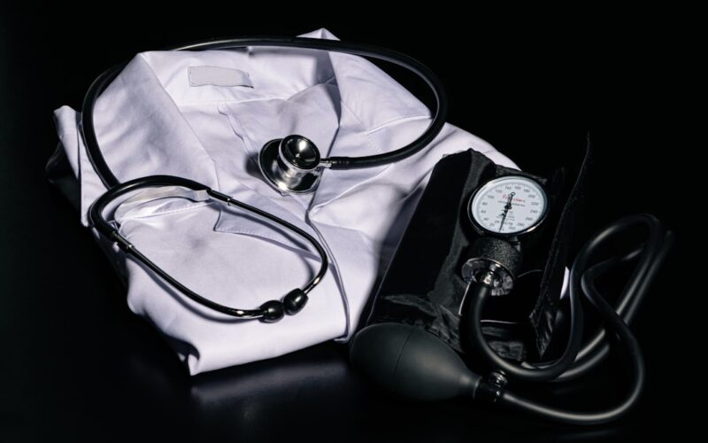 black and silver stethoscope on white textile