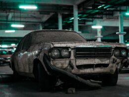 unwashed white sedan parked inside building's parking lto