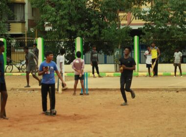 a group of people playing a game of cricket