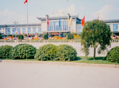 A large building with a lot of flags in front of it