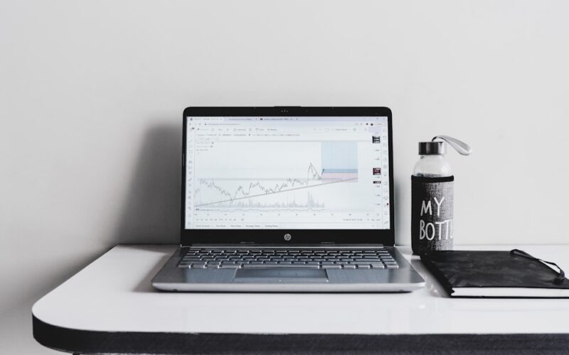 a laptop computer sitting on top of a white desk