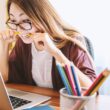 High Cortisol Levels Linked to Reduced Brain Volume and Impaired Memory, Studies Show 7 woman biting pencil while sitting on chair in front of computer during daytime
