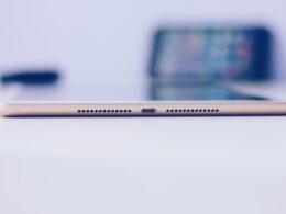 gold iPad mini on white surface