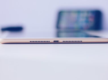 gold iPad mini on white surface