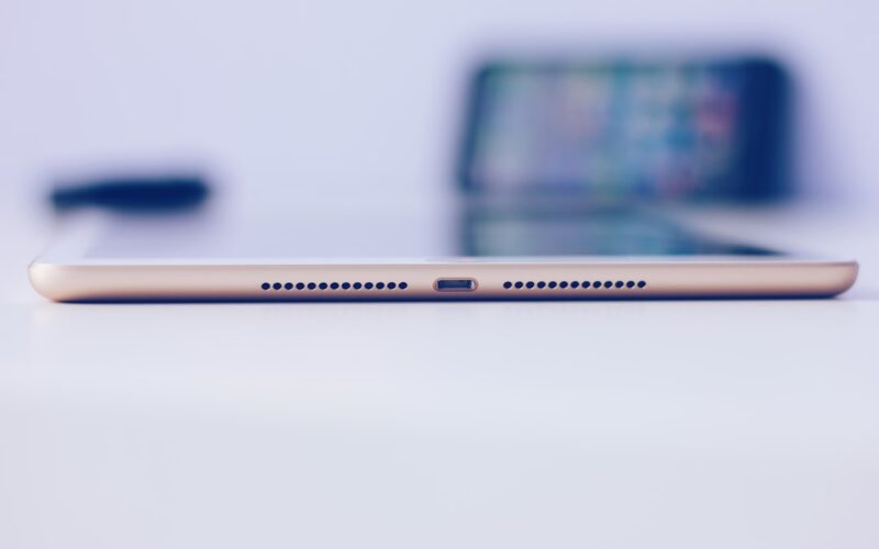 gold iPad mini on white surface