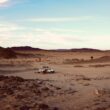 a truck is driving through a desert area