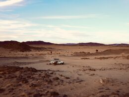 a truck is driving through a desert area
