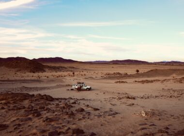 a truck is driving through a desert area