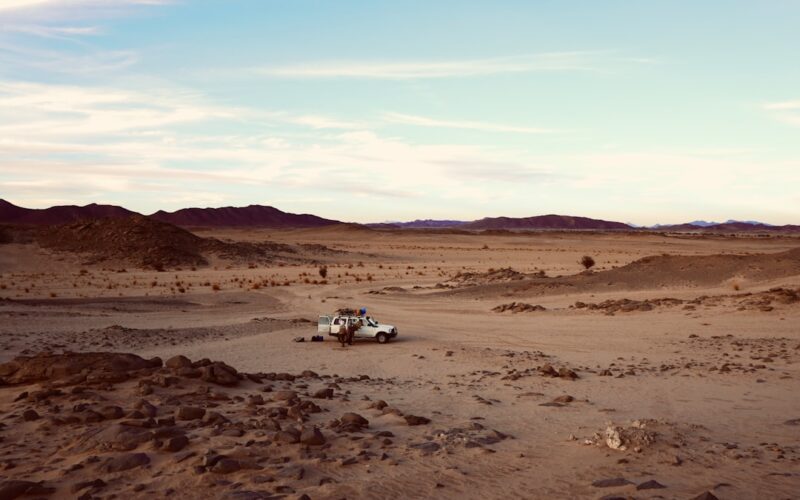 a truck is driving through a desert area