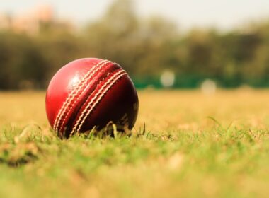 red and white ball on green grass during daytime