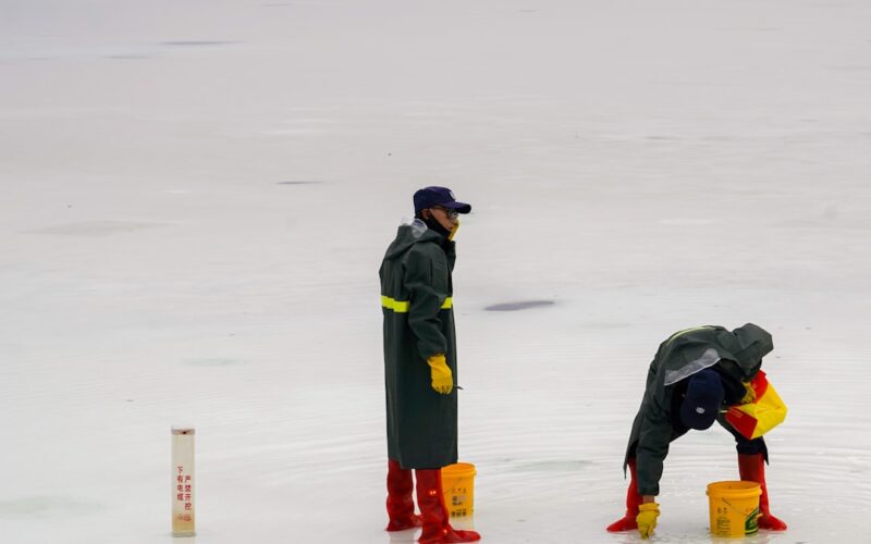 a couple of people that are standing in the snow