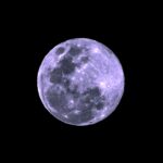 a full moon is seen in the dark sky