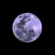 a full moon is seen in the dark sky