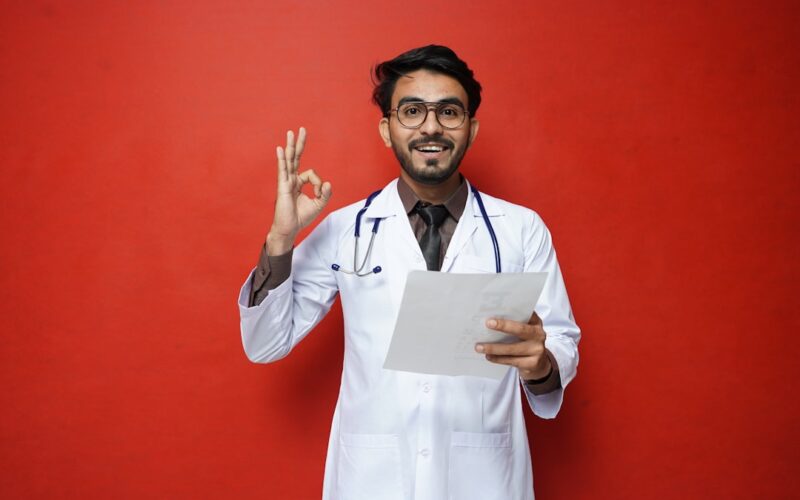 a man in a white coat holding a piece of paper