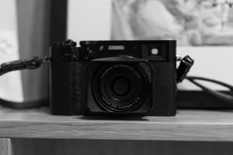 a black and white photo of a camera on a table