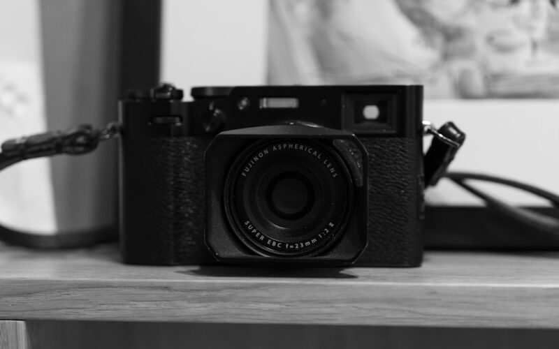 a black and white photo of a camera on a table