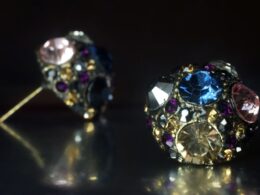 a close up of a pair of earrings on a table