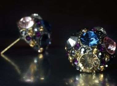 a close up of a pair of earrings on a table