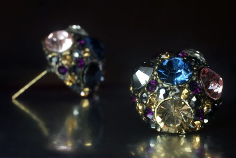 a close up of a pair of earrings on a table