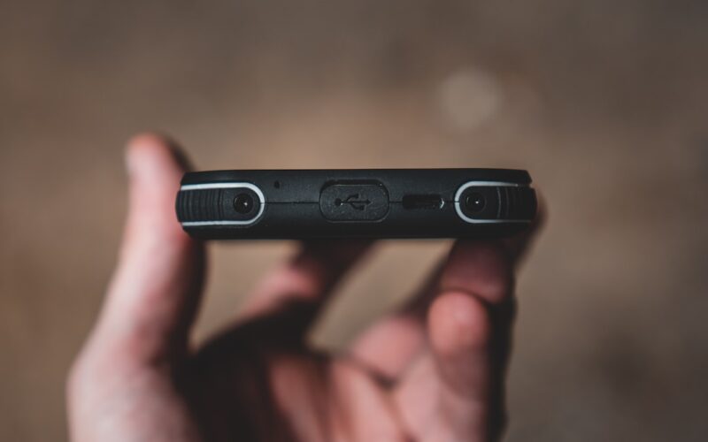 person holding black flash drive