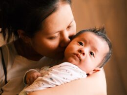 a woman holding a baby in her arms