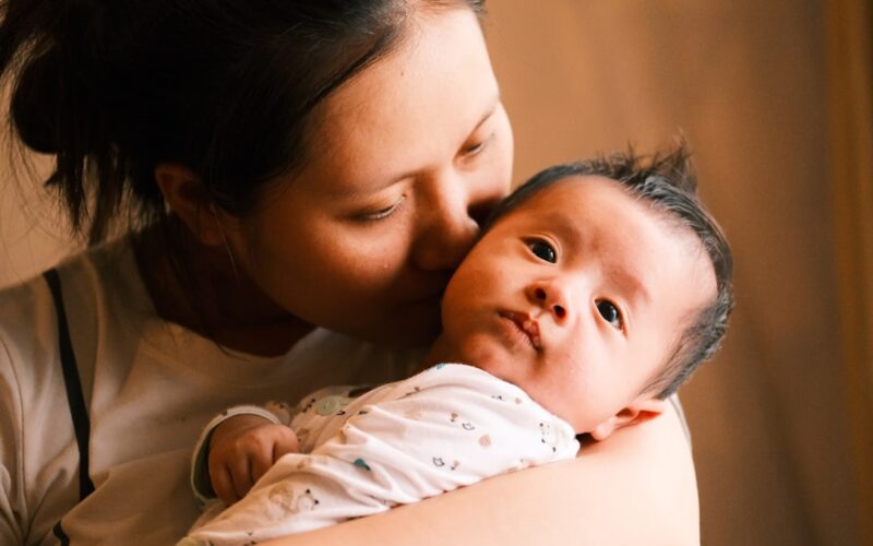 a woman holding a baby in her arms