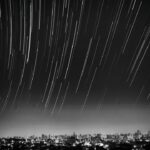 grayscale photo of meteor shower