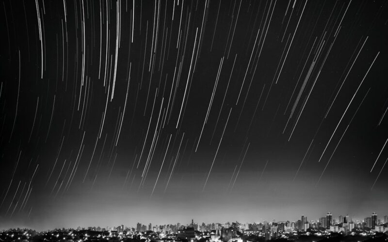 grayscale photo of meteor shower