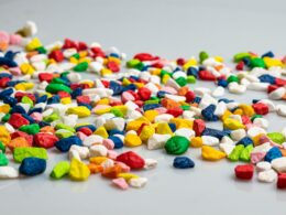 A pile of colorful candy corn on a white surface