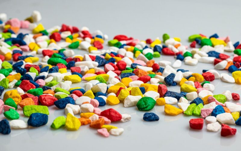 A pile of colorful candy corn on a white surface