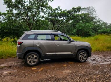 A car is parked on a muddy road