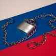 a lock and chain on a red, blue, and red background