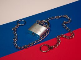 a lock and chain on a red, blue, and red background