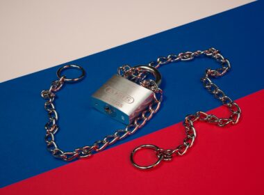 a lock and chain on a red, blue, and red background