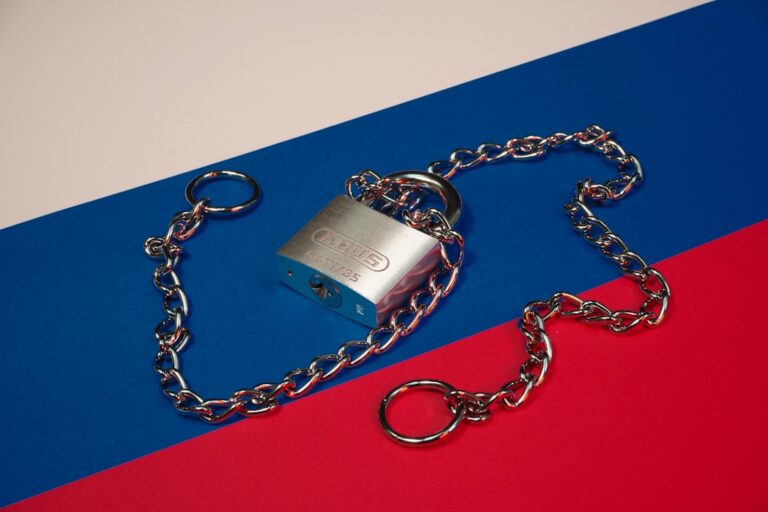 a lock and chain on a red, blue, and red background