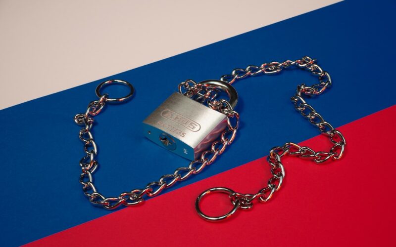 a lock and chain on a red, blue, and red background