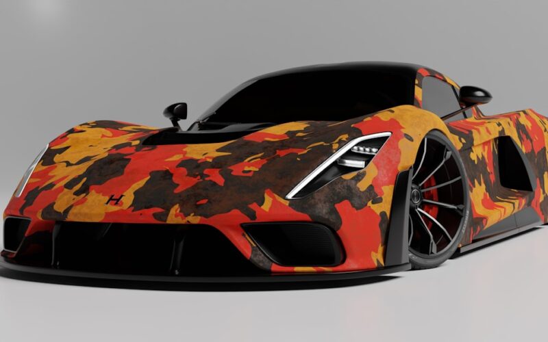 an orange and black sports car on a gray background