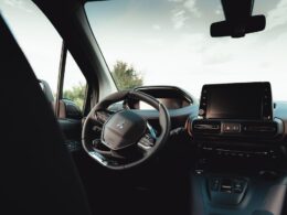 the interior of a car with a steering wheel and dashboard