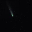 A bright comet with a long tail in starry sky