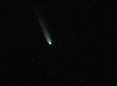 A bright comet with a long tail in starry sky